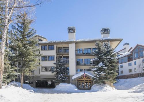 a large building in the snow with trees at Townsend Place B202 Condo in Beaver Creek