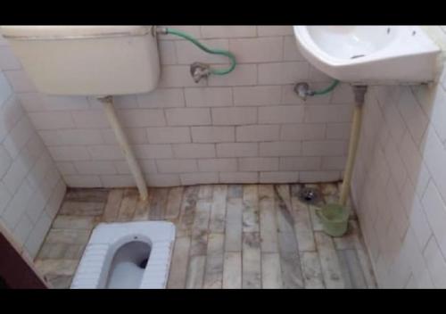a dirty bathroom with a toilet and a sink at Zeal Guesthouse By WB Inn in Kānpur