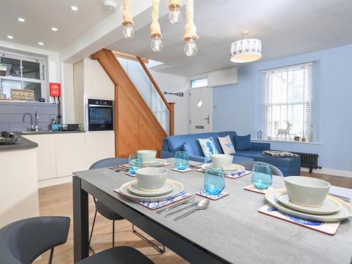 a dining room and kitchen with a table and chairs at Rock and Reel in Dartmouth