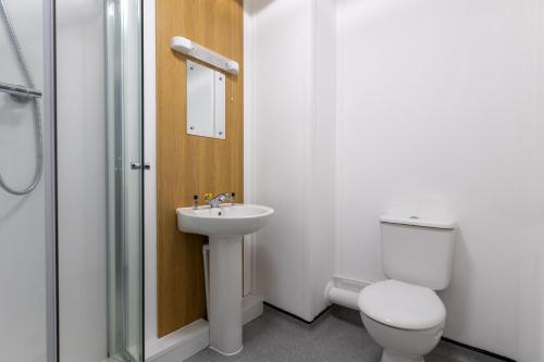 a bathroom with a toilet and a sink and a shower at Nightel Hotel in Kirmington