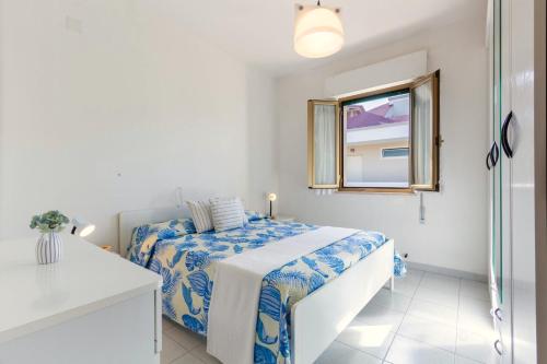 1 dormitorio con cama y ventana en Appartamento Attico Vespucci - MyHo Casa, en Tortoreto Lido