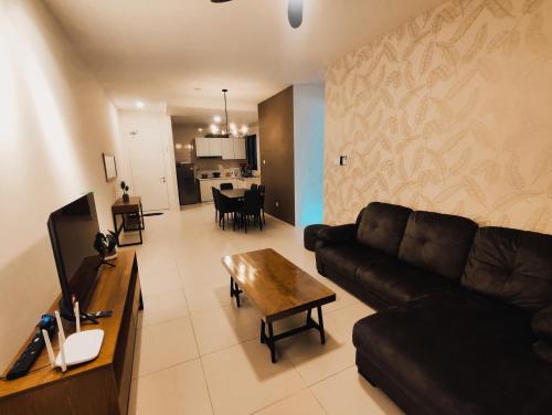 a living room with a couch and a table at Banana Homestay Kuching - P' Residence in Kuching