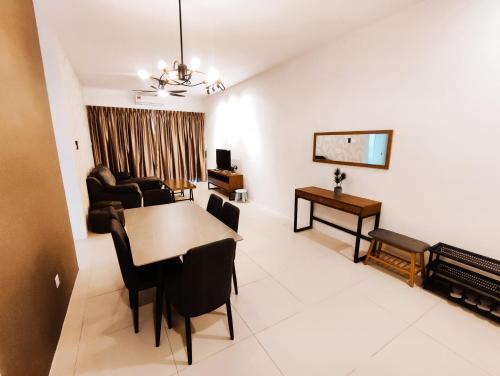a living room with a table and a dining room at Banana Homestay Kuching - P' Residence in Kuching