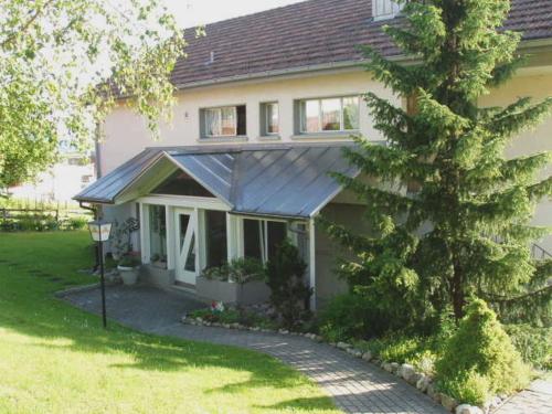 a house with a tree in front of it at Gasthaus zum Rössli in Triengen
