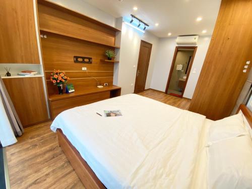 a bedroom with a large white bed in a room at Luxe Paradise Residence Trinh Cong Son in Hanoi