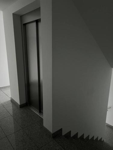 a hallway with two glass doors in a building at Dill Apartments Stederdorf in Peine