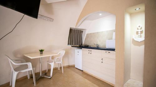 a kitchen with a table and chairs in a room at Dor village in Dor
