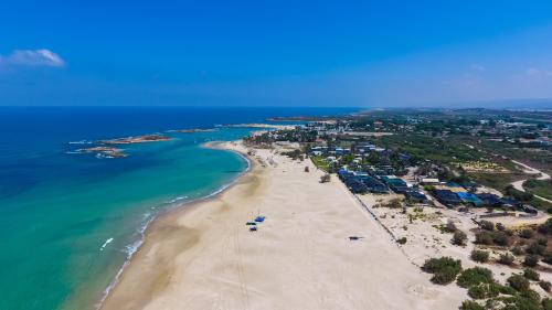 an aerial view of a beach and the ocean at Dor village in Dor