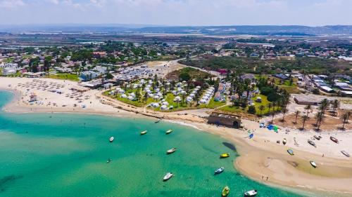 an aerial view of a beach with boats in the water at Dor village in Dor