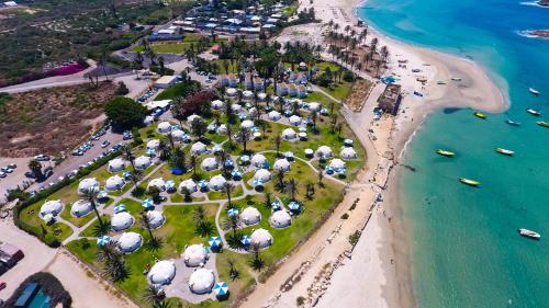 an aerial view of a beach with umbrellas at Dor village in Dor
