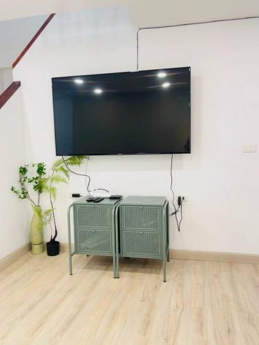 a flat screen tv hanging on a wall at BKK Villa/Huaikwang China Twon in Bangkok