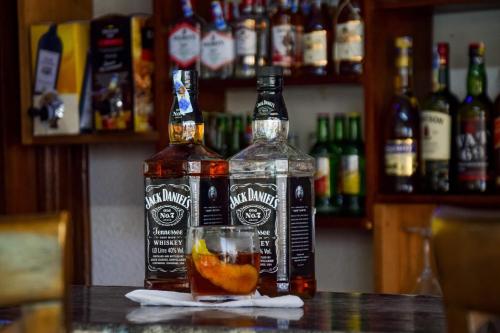 two bottles of alcohol sitting on a table with a drink at Sheratton Beach Villagio in Mombasa