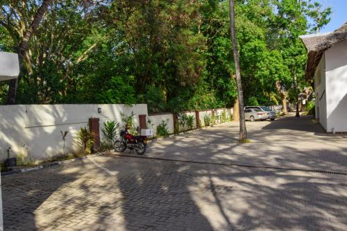 a bike parked on a sidewalk next to a fence at Sheratton Beach Villagio in Mombasa