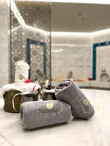 a pair of socks sitting on the floor in a bathroom at Naturelife Bungalows & SPA in Cıralı