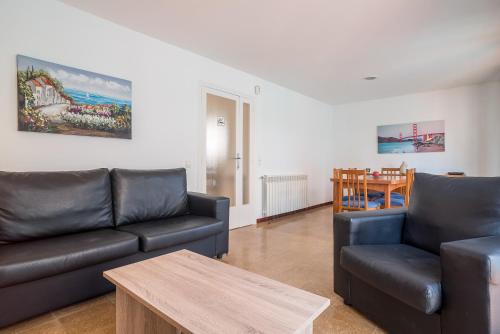 a living room with a couch and a table at Canet beach 3 in Canet de Mar
