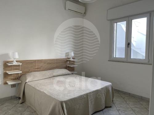 En eller flere senge i et værelse på Casa Picci By Cala Salento