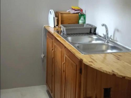 a kitchen with a sink and a counter top at Royal Karoo Cottage unit 1 in Beaufort West
