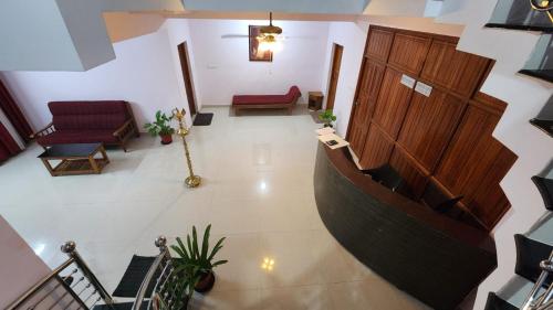an overhead view of a lobby with a large wooden door at SkyLounge Residency in Trivandrum
