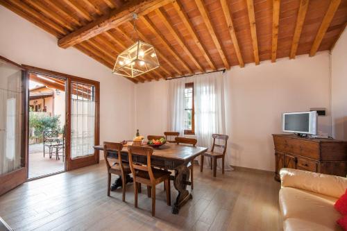 a dining room with a table and a tv at Fattoria San Lorenzo in Grosseto