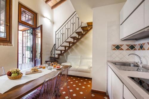 a kitchen and living room with a table and chairs at Fattoria San Lorenzo in Grosseto