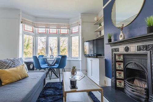 a living room with a couch and a fireplace at Calverley Place -Long Stay Offer in Royal Tunbridge Wells
