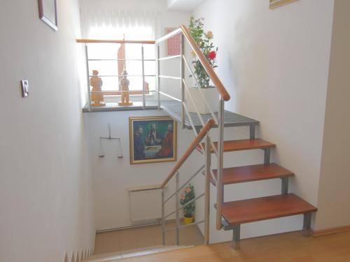 a stairwell in a home with a spiral staircase at Pansion Danica in Rastovača
