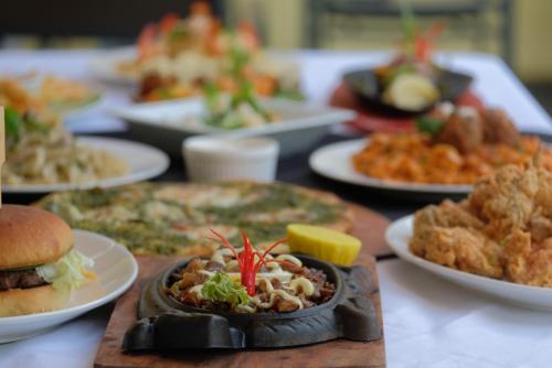 a table full of plates of food on a table at Villa Italia Hotel in Sorsogon