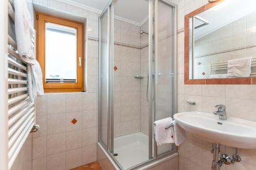 a bathroom with a shower and a sink at lechner living apartments in Wald im Pinzgau