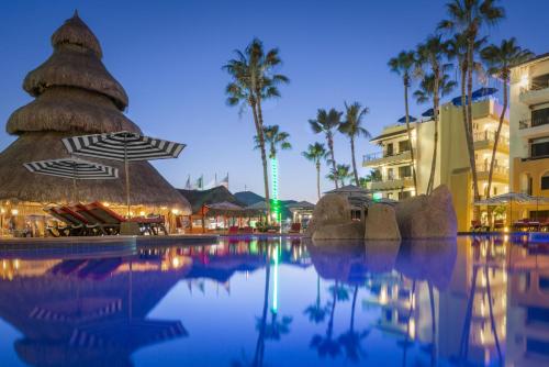 a swimming pool at a resort at night at Cabo San Lucas Marina Condos in Cabo San Lucas