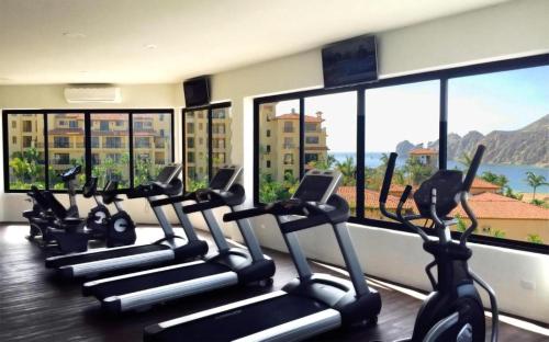 a row of cardio machines in a gym with windows at Cabo San Lucas Marina Condos in Cabo San Lucas