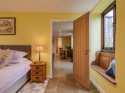 a bedroom with a bed and a window at Bradley Stables in Minehead