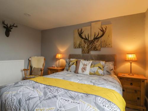 a bedroom with a bed and two lamps and two chairs at Ramblers Retreat in Settle