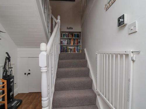 a staircase with a book shelf in the wall at Ramblers Retreat in Settle