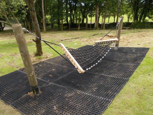 a hammock tied to a pole in a park at Birch Lodge 12 with Hot Tub in Newton Stewart