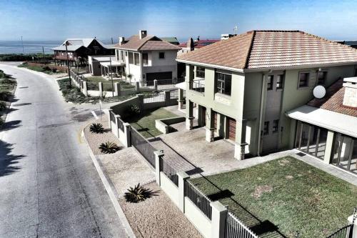 an aerial view of a house next to a street at Luxury Beachhouse Villa II in Wilderness