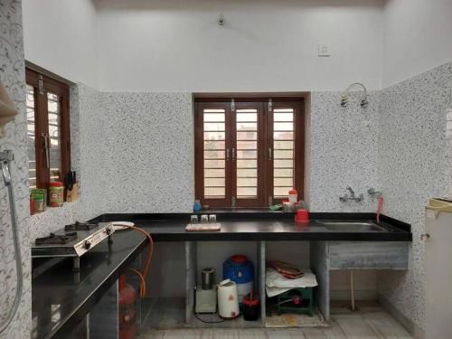 a kitchen with a sink and a counter top at Entire Villaa in Jodhpur