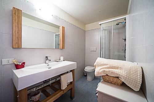 a bathroom with a white sink and a shower at Le Thovex in La Thuile