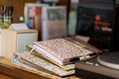 a stack of books sitting on top of a table at Le Vallon d'Armandine, gîte écologique Auvergne in Saint-Hilaire
