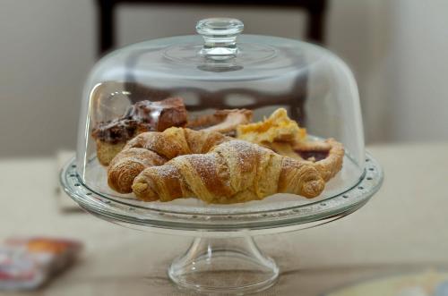 a glass dish filled with pastries and other desserts at Hotel Victoria in Torre Santa Sabina