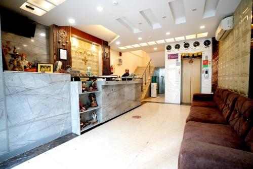 a restaurant with a bar with brown leather seats at Hotel Silver Stone - Karol Bagh New Delhi in New Delhi