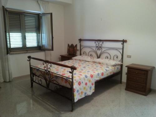 a bedroom with a bed and a dresser and a window at Rosa di Calabria in Bovalino Marina