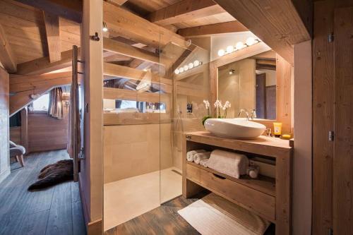 ein Bad mit einem Waschbecken und einer Dusche in der Unterkunft Chalet Opale in Tignes