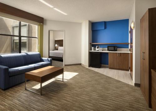 a living room with a couch and a table at Holiday Inn Express Hotel & Suites Irving DFW Airport North by IHG in Irving