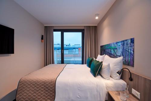Posteľ alebo postele v izbe v ubytovaní Leonardo Hotel Vienna City West