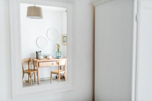 a dining room with a table and chairs through a door at Dimora Santa Caterina in Polignano a Mare