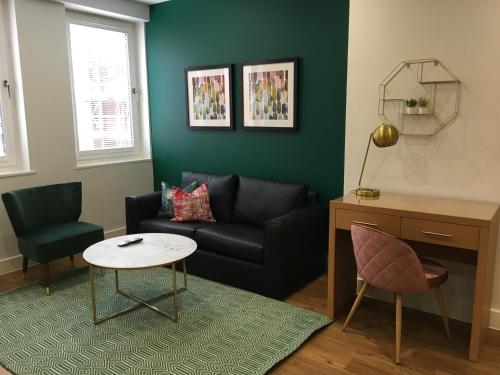 a living room with a couch and a table at House of Fisher - 100 Kings Road in Reading