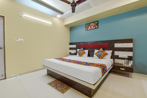 a bedroom with a bed in a room at FabExpress Apollo - Nr Odhav Ring Road in Naroda