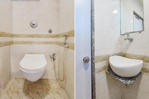 a bathroom with a toilet and a sink at FabExpress Apollo - Nr Odhav Ring Road in Naroda