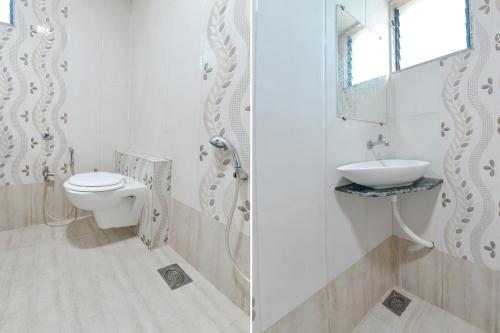 a bathroom with a toilet and a sink at FabExpress Apollo - Nr Odhav Ring Road in Naroda