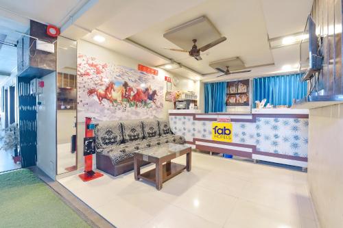 a living room with a couch and a table at FabExpress Apollo - Nr Odhav Ring Road in Naroda